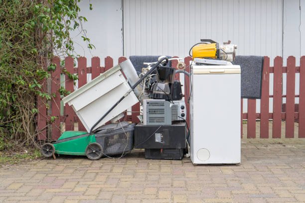 bulky garbage heap with old electronic devices on the side of the road