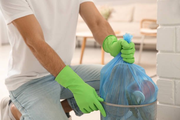 man taking garbage bag out of bin at home, closeup
