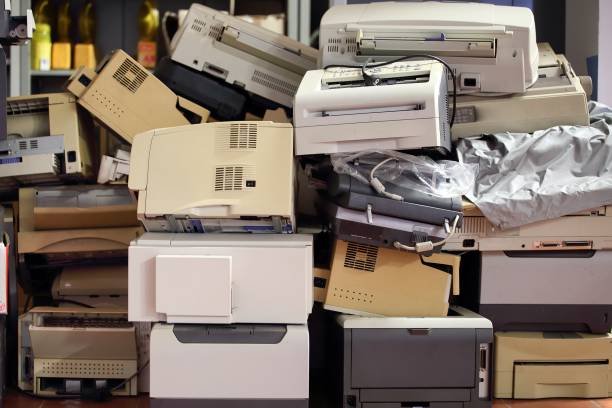 stack of disused computer printers to be scrapped or recycled.