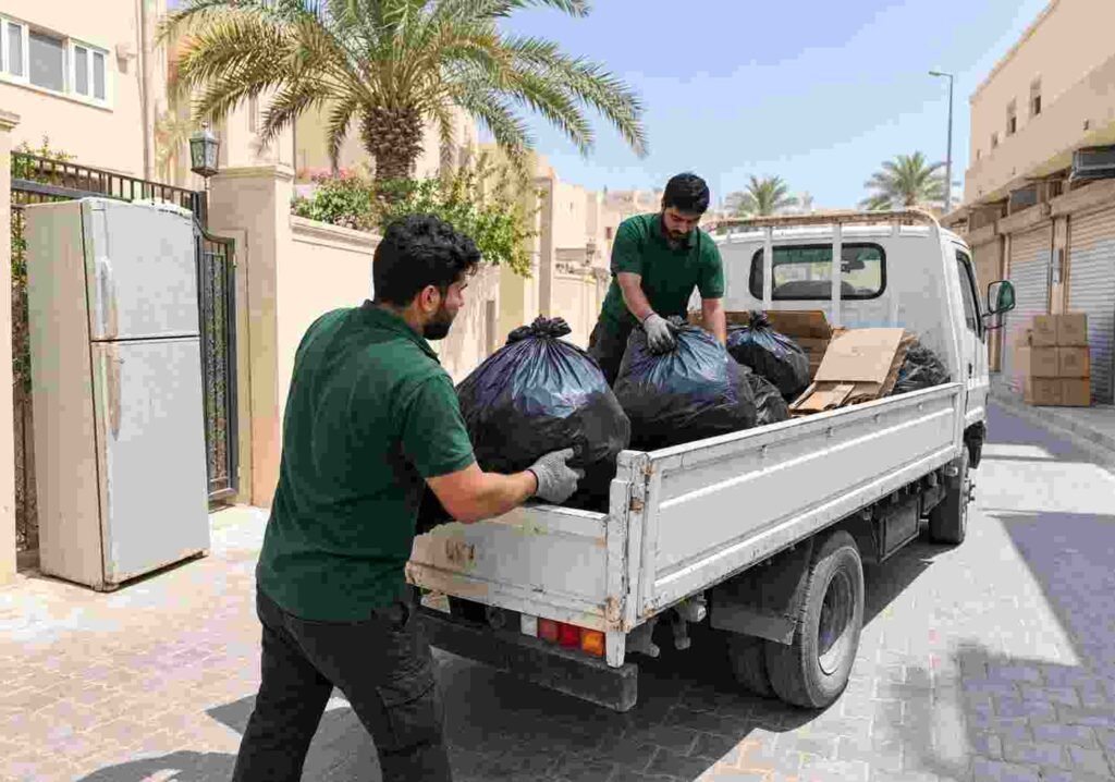 Professional waste removal services in Dubai: worker rolling a waste bin up a ramp onto a truck
